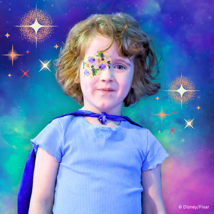 Child in a cape wearing a Disney and Pixar Elio eye patch