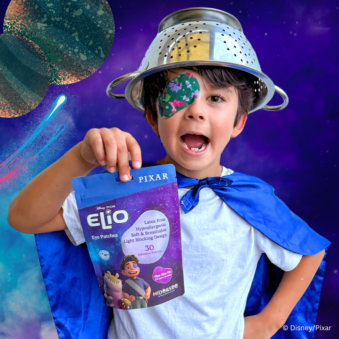 Boy with a colander helmet holding the Elio pack, wearing an Elio eye patch