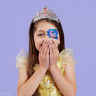 Girl in a Belle dress and tiara covering her smile, wearing a Disney Princess eye patch