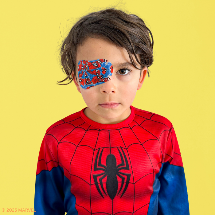 Boy in a Spider-Man costume wearing a blue Spider-Man eye patch