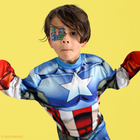 Boy in a Captain America costume wearing a multi-colour Avengers eye patch